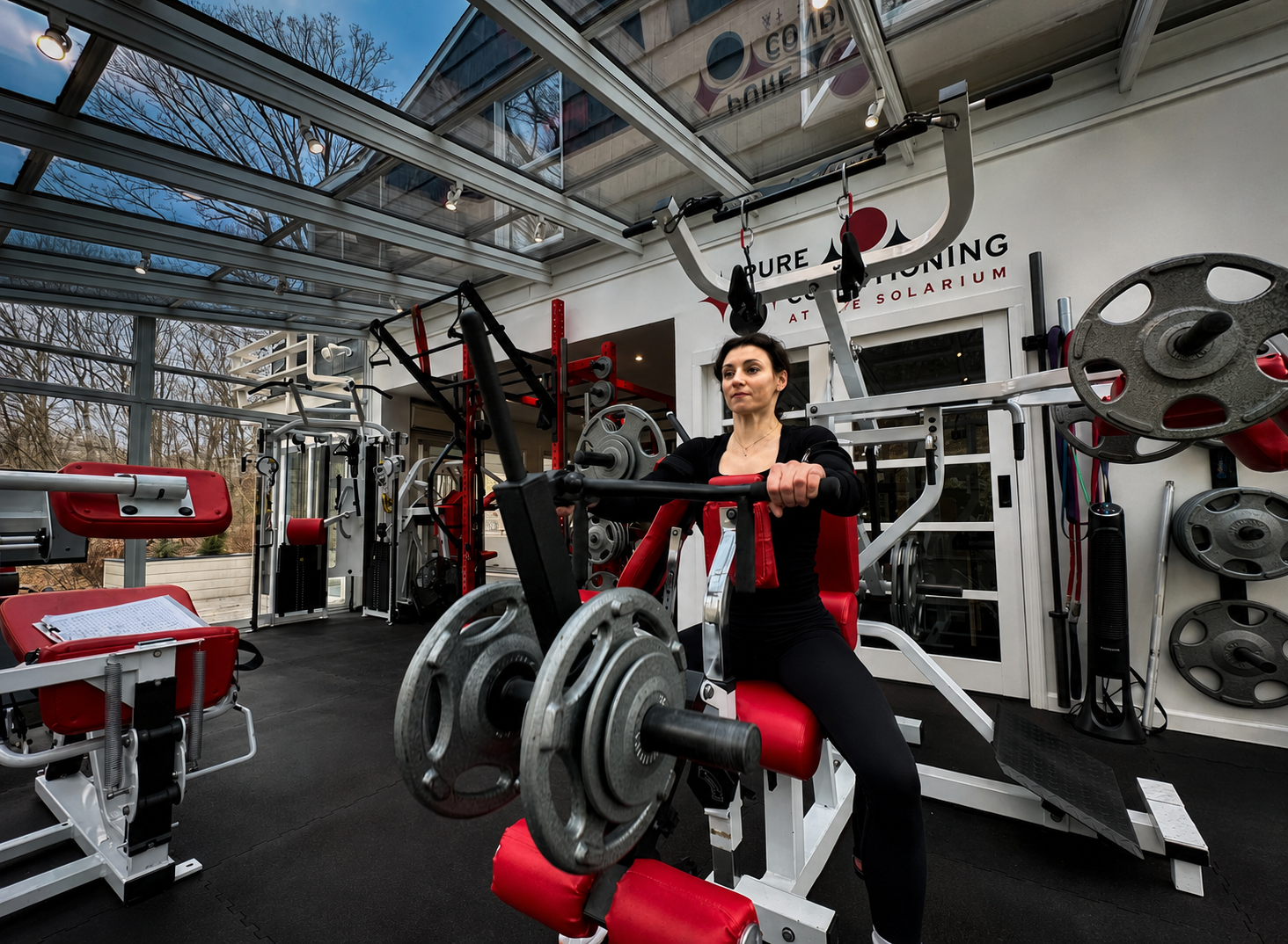 Personal trainer in Stamford CT coaching a client through seated strength training at Pure Conditioning.