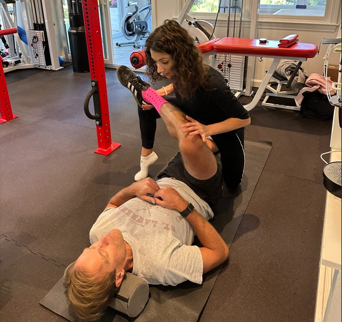 Trainer guiding assisted stretching at Pure Conditioning in Stamford, CT