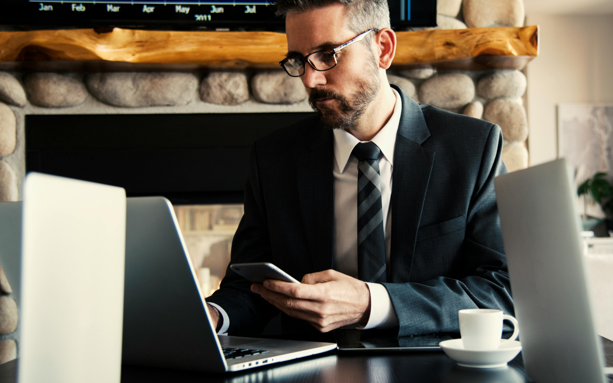 Busy professional using laptop and phone for virtual personal training flexibility