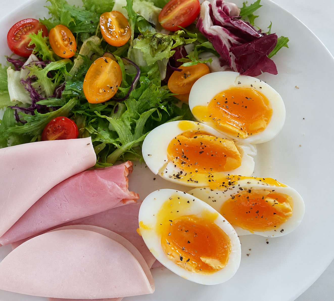 Person planning a meal beside breakfast and a notebook for nutrition consulting support