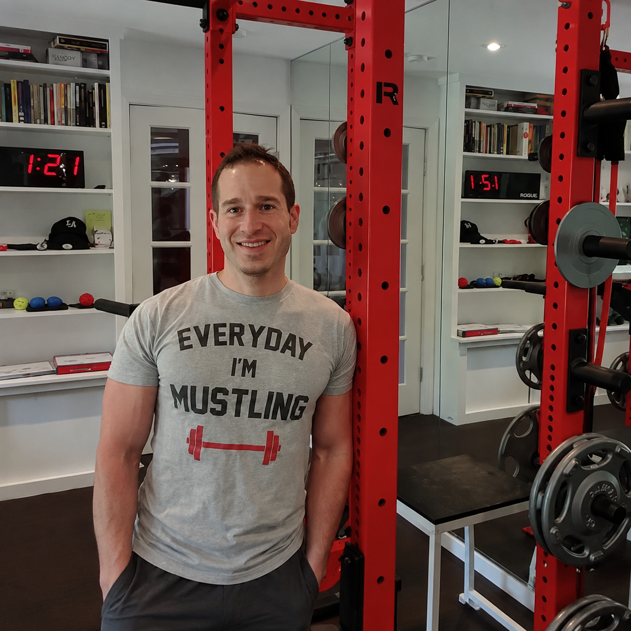 Pure Conditioning Stamford training solarium with founder standing beside custom red strength training equipment