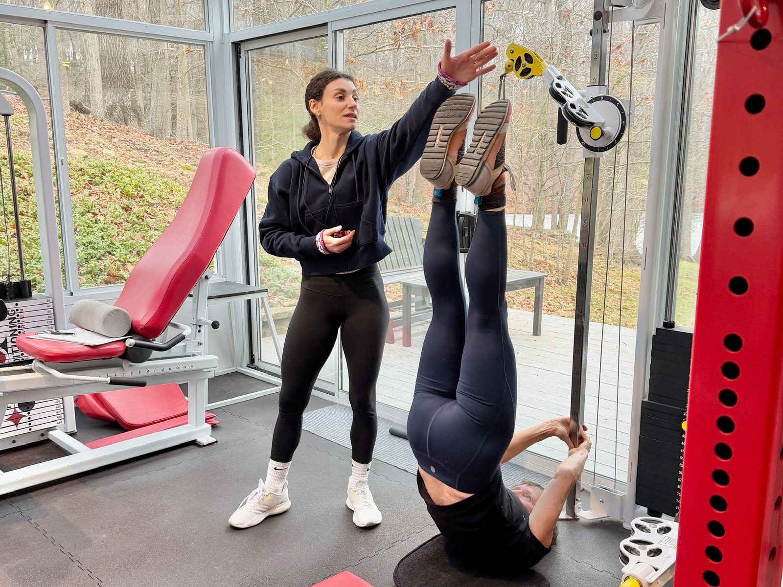 Coach supervising a client through an exercise at the Solarium